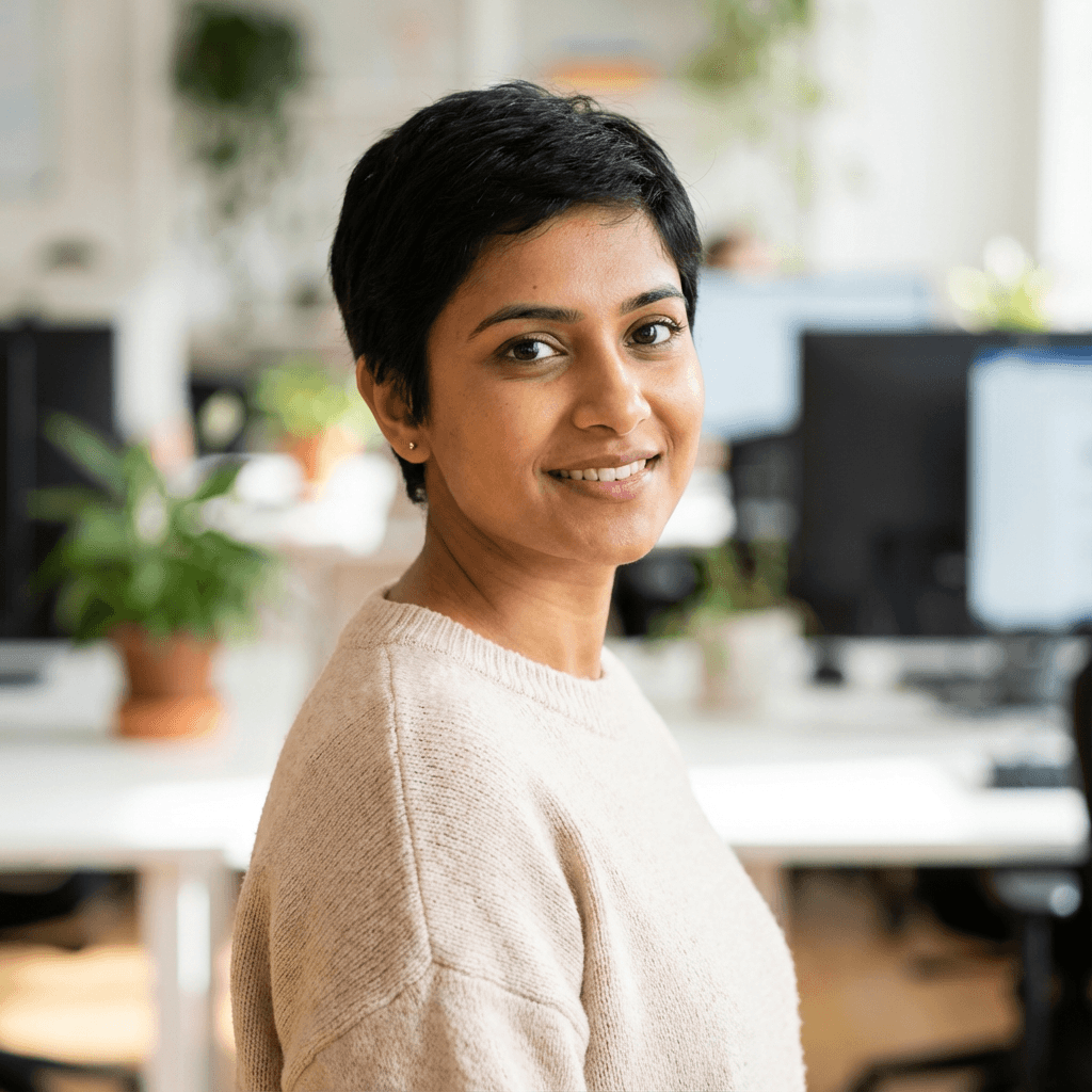 Amara J. smiling while using her phone for a telemedicine appointment